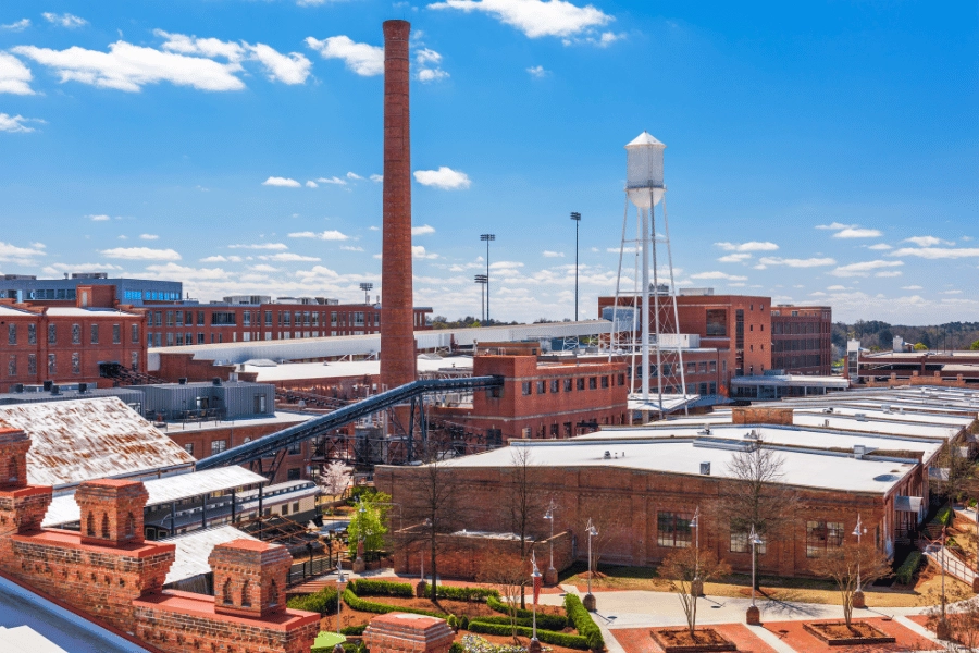 warehouse district in Durham, NC with lots of brick buildings and white water tower